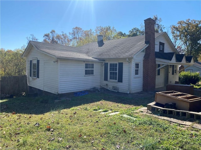 rear view of house with a yard