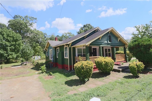 exterior space featuring a porch and a front lawn