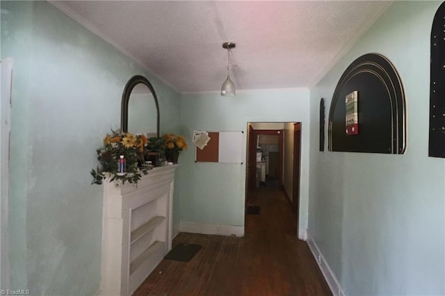 hallway with ornamental molding and hardwood / wood-style floors