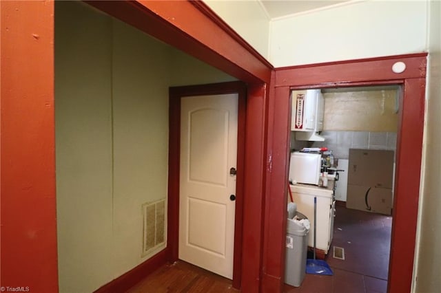 hall with dark wood-type flooring and water heater