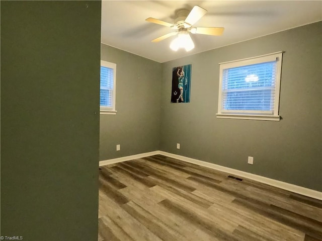 empty room featuring hardwood / wood-style flooring and ceiling fan