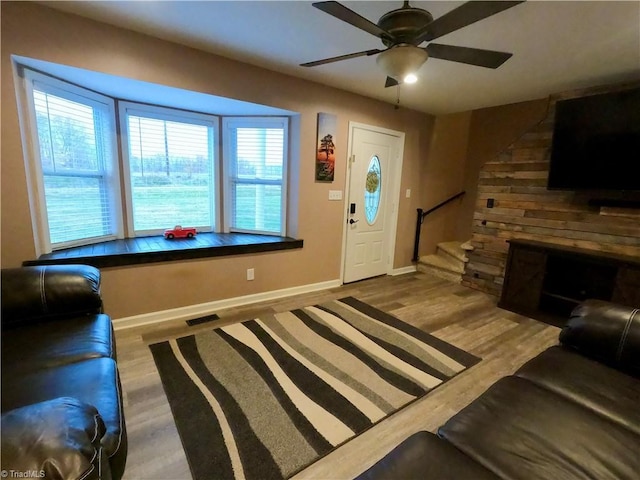 living room with ceiling fan and wood-type flooring