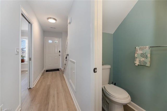 bathroom featuring wood finished floors, toilet, and baseboards