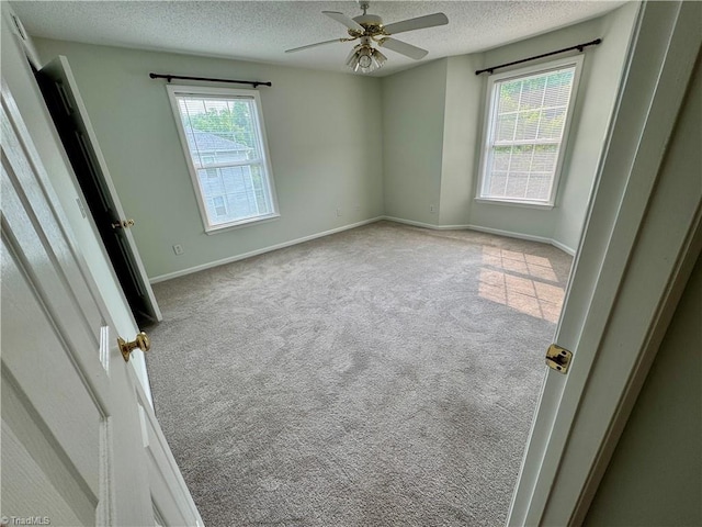 733 Rivertree Ln, Winston-Salem, NC 27103 - carpeted spare room featuring a textured ceiling, plenty of natural light, a ceiling fan, and baseboards