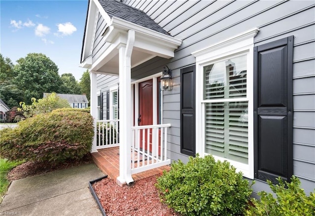 view of exterior entry with a porch