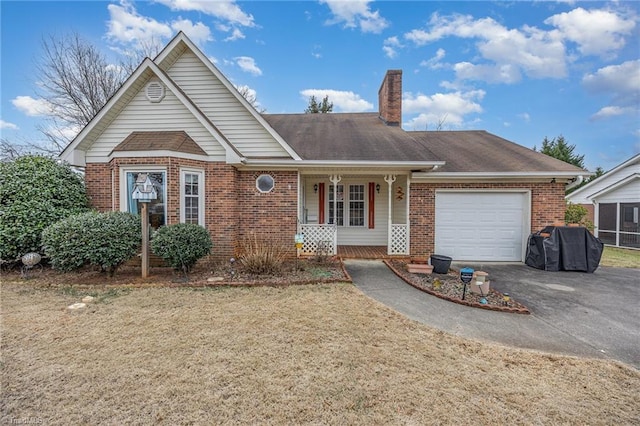 single story home featuring a garage, a front lawn, and a porch