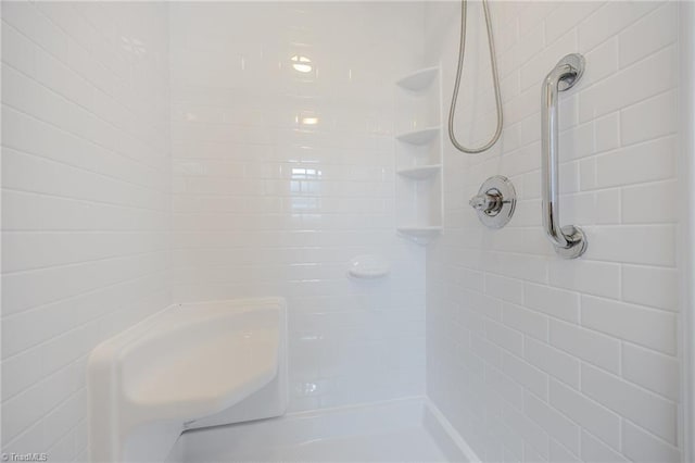 bathroom with tiled shower