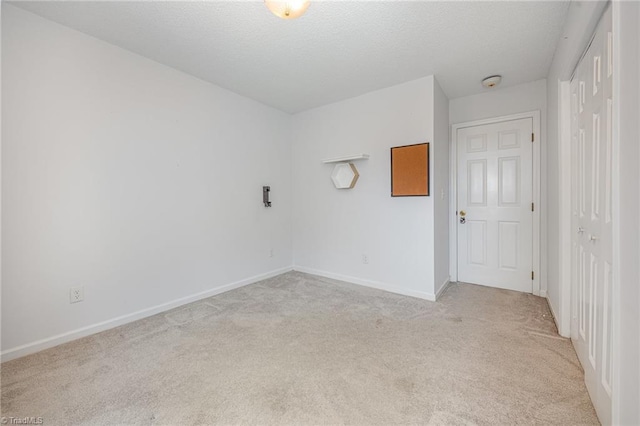 unfurnished room featuring light colored carpet