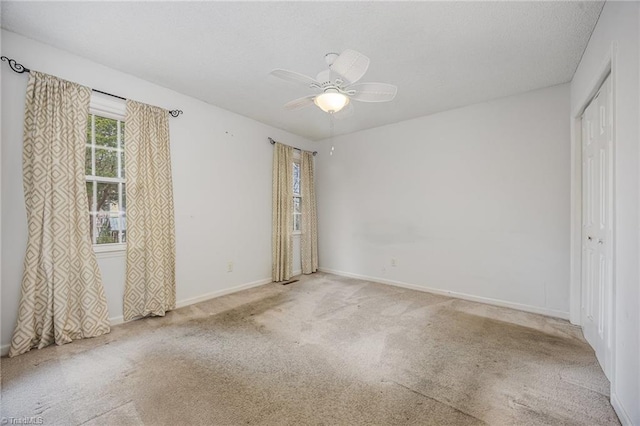 carpeted empty room with ceiling fan