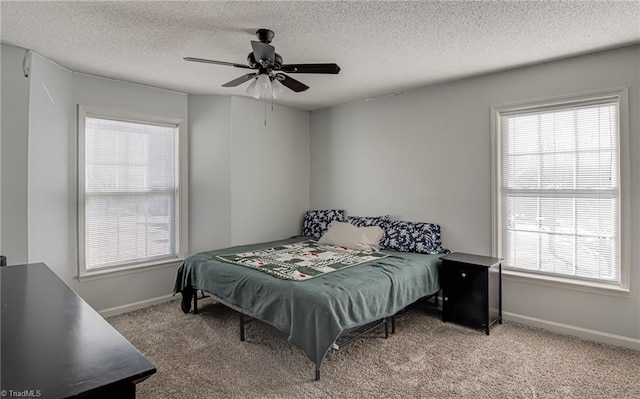 bedroom featuring multiple windows, light carpet, and ceiling fan