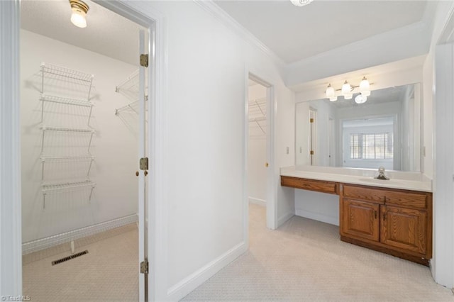 bathroom featuring ornamental molding and vanity