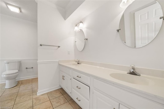 bathroom with vanity, toilet, and tile patterned flooring