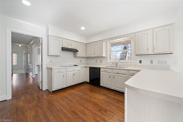 kitchen with sink, dark wood-type flooring, white cabinetry, black appliances, and ornamental molding