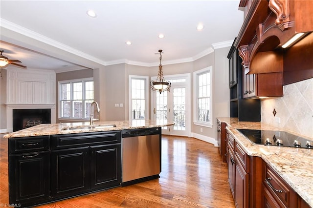 kitchen with black electric cooktop, tasteful backsplash, decorative light fixtures, dishwasher, and sink