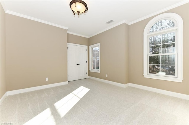 carpeted spare room with ornamental molding