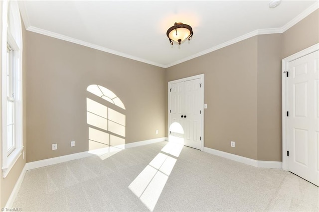 unfurnished bedroom with crown molding and light carpet