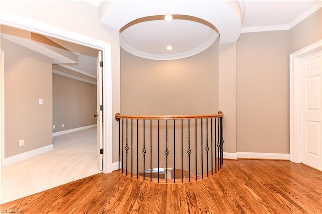 corridor featuring wood-type flooring and crown molding