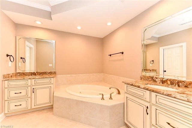 bathroom with tile patterned flooring, ornamental molding, vanity, and a relaxing tiled tub