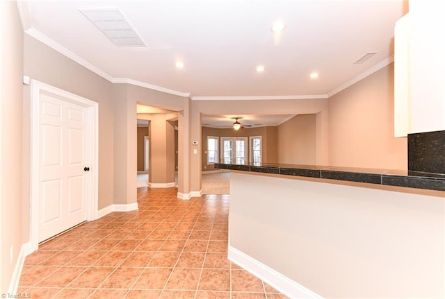 hallway with light tile patterned floors and crown molding