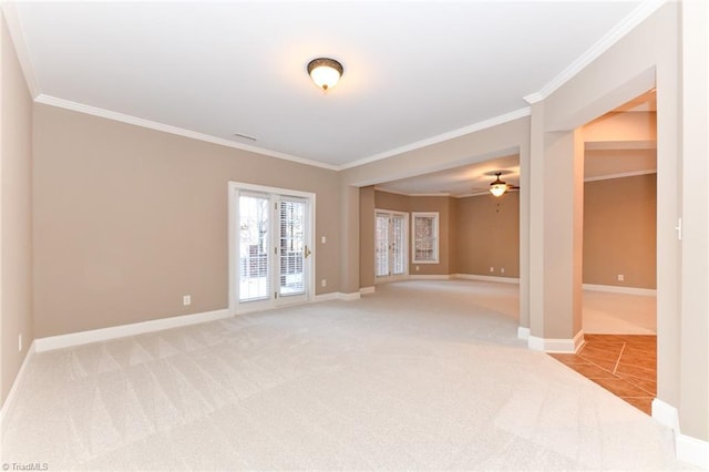 carpeted spare room featuring ceiling fan and crown molding