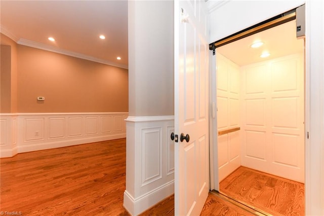 bathroom featuring wood-type flooring and crown molding