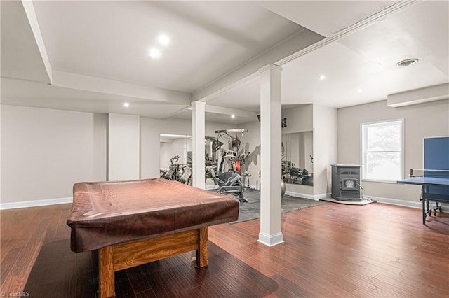 game room with baseboards, billiards, wood finished floors, and a wood stove