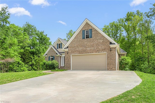 traditional-style house featuring concrete driveway, brick siding, an attached garage, and a front lawn