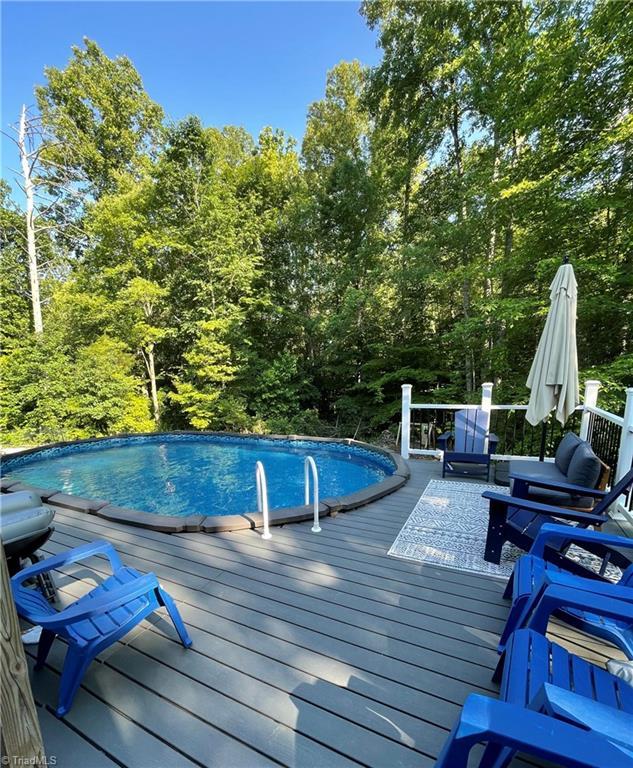 outdoor pool with a wooden deck