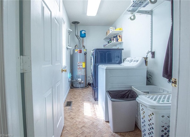 laundry area featuring gas water heater and independent washer and dryer