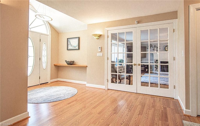 foyer with wood-type flooring and french doors