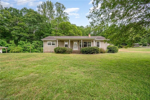 single story home with a porch, a front yard, and a chimney