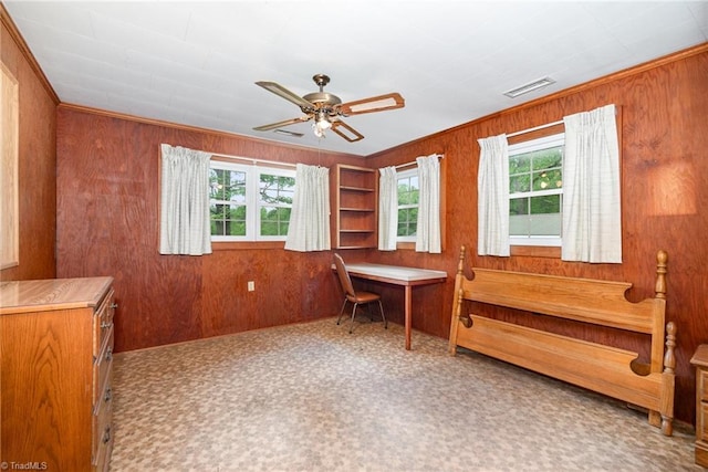 home office featuring wood walls and a ceiling fan