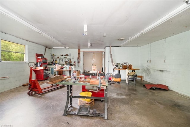 garage featuring concrete block wall and a workshop area