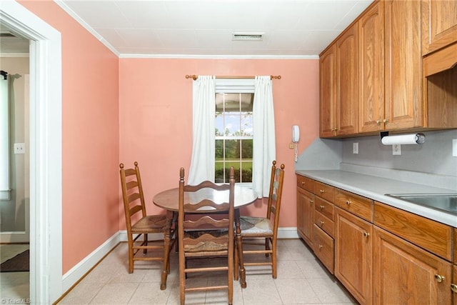 dining area with crown molding and baseboards