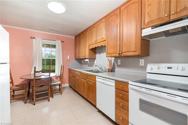 kitchen with white appliances, a sink, under cabinet range hood, light countertops, and brown cabinets