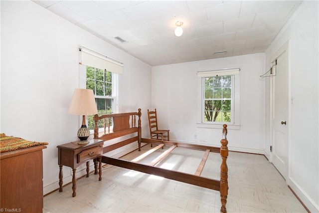 bedroom featuring multiple windows, tile patterned floors, and baseboards