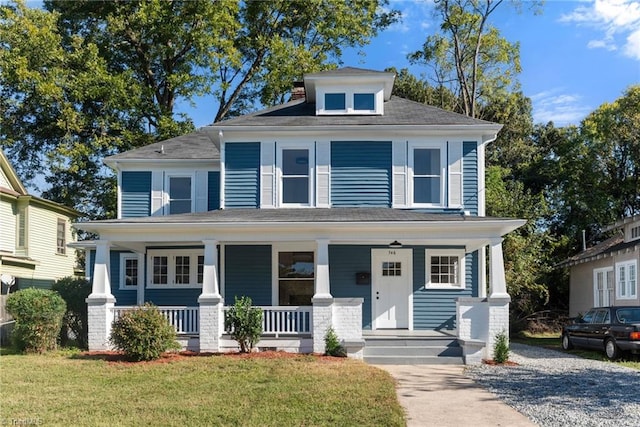 view of front facade with a front yard and a porch