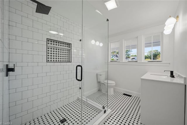 bathroom with vanity, toilet, and an enclosed shower