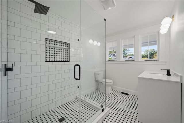 bathroom with walk in shower, vanity, and toilet