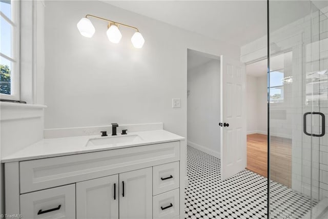 bathroom with an enclosed shower, hardwood / wood-style flooring, and vanity