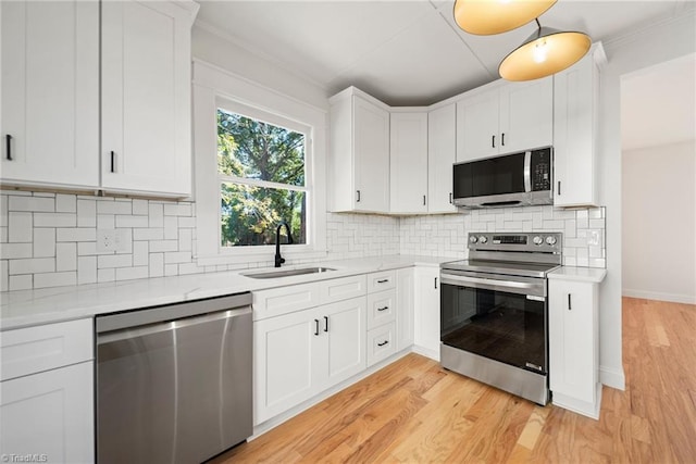 kitchen featuring light wood-type flooring, white cabinetry, sink, and stainless steel appliances