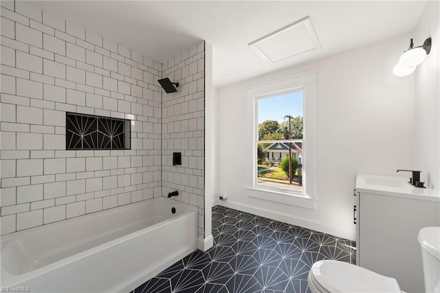 full bathroom featuring tiled shower / bath combo, tile patterned floors, vanity, and toilet