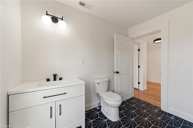 bathroom with tile patterned floors, vanity, and toilet