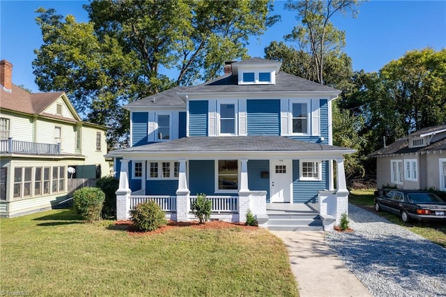 view of front facade with a porch and a front lawn