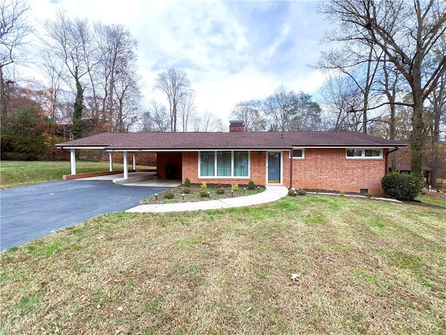 ranch-style house with a front lawn and a carport