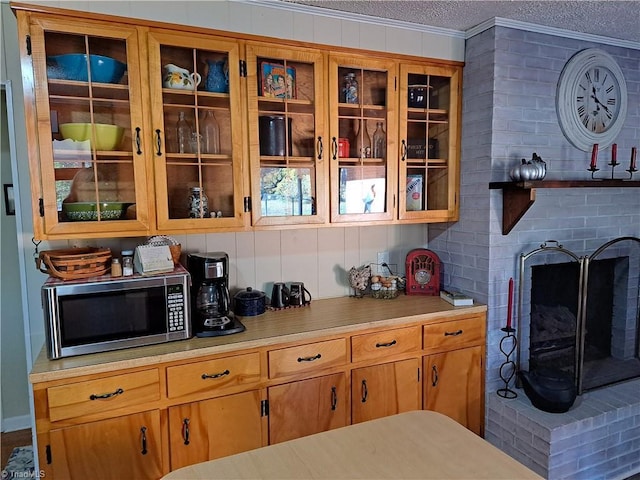 kitchen with a textured ceiling and crown molding