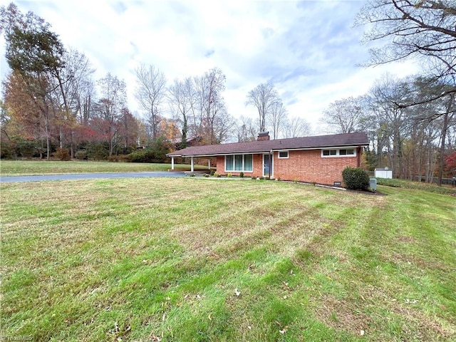 view of front of house featuring a carport and a front lawn