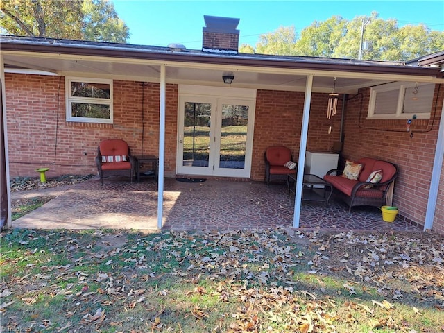 rear view of house with a patio area and french doors