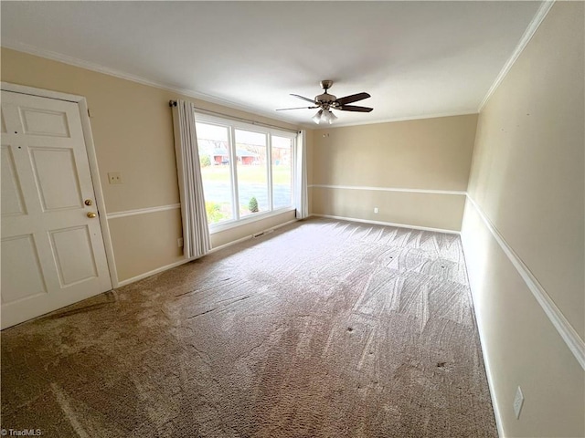 spare room with carpet floors, ceiling fan, and crown molding