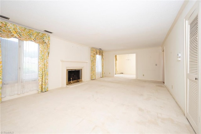 unfurnished living room with carpet flooring, visible vents, and a fireplace